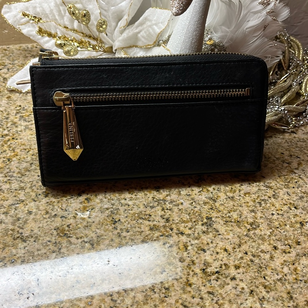 Perkins New York black leather feel wallet. Probably vegan leather? Unknown.
